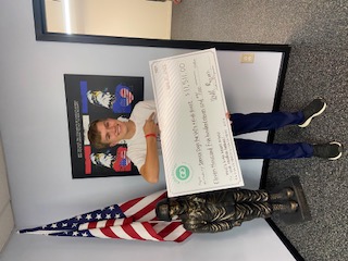 Will Ryan holding a donation check for Service Dogs for Veterans